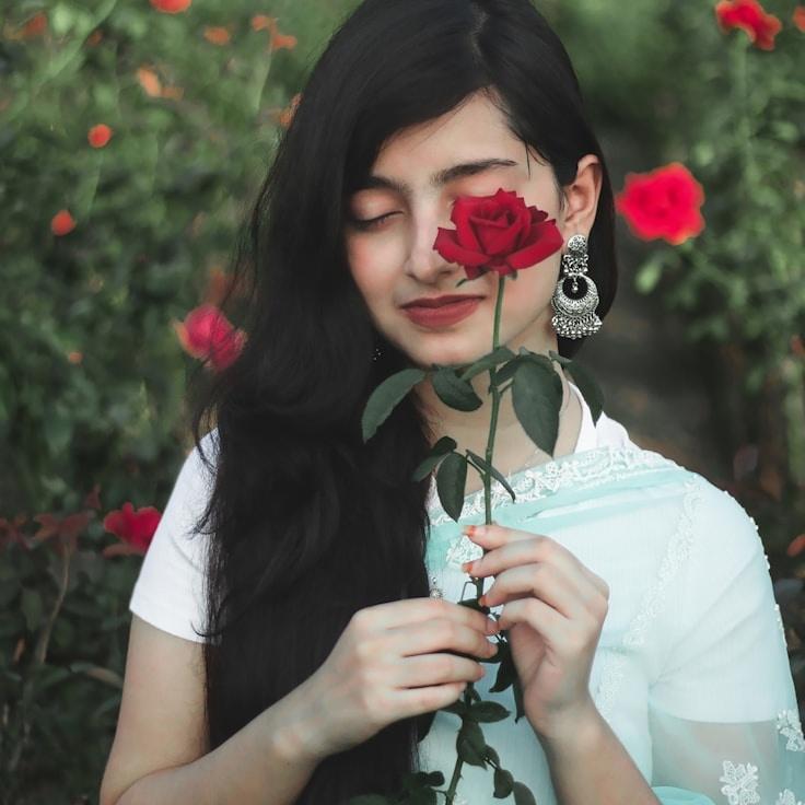 Avery Rivera, Lead Design Curator at Global Asset Platform, reviewing corporate floral arrangements